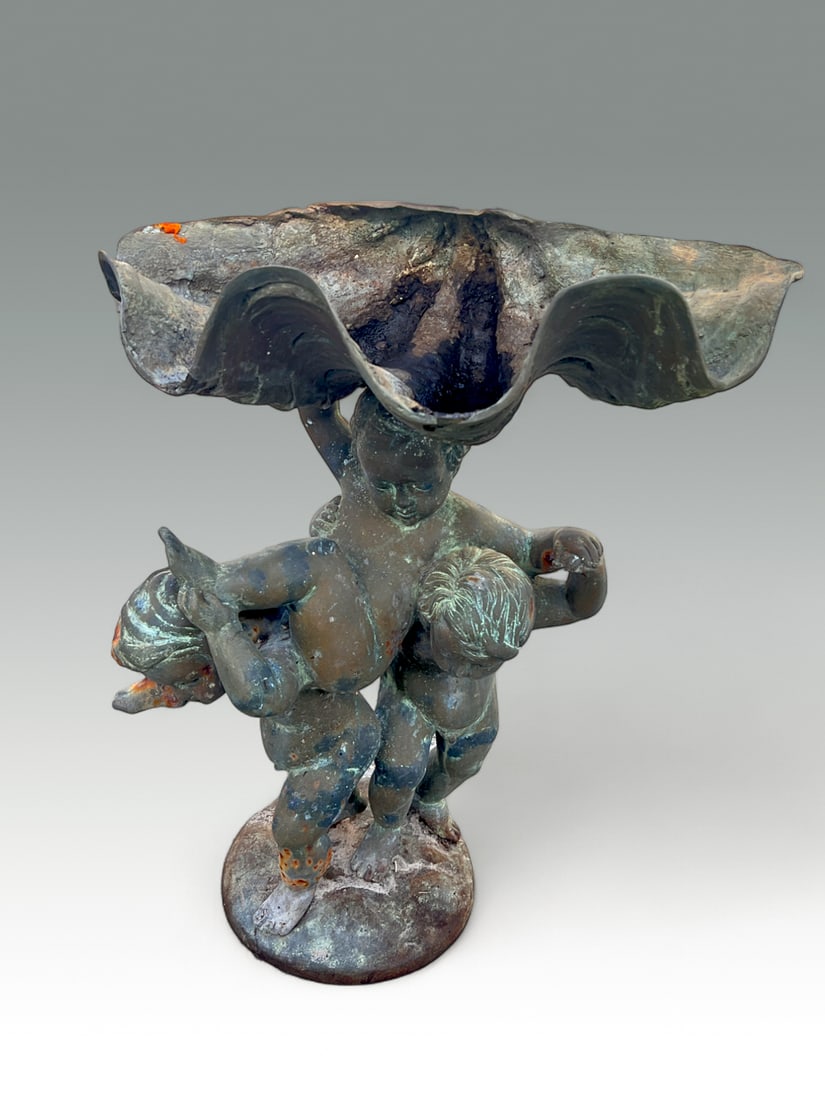 BRONZE BIRD BATH FROLICKING PUTTI WITH CLAM: BRONZE BIRD BATH FROLICKING PUTTI WITH CLAM: 3 Playful Putti with a large Clam shaped bowl. Approx. 30" h x 23.5" w x 15.5" d.