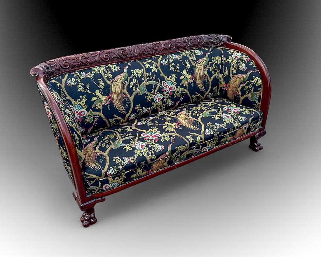 CARVED ANTIQUE HORNER STYLE SOFA: CARVED ANTIQUE HORNER STYLE SOFA: Relief carved crest rail and paw feet in the manner of RJ Horner, New York. Birds & Butterflies amongst foliage pattern upholstery. Approx. 34" h x 64.75" w x 29.5" d