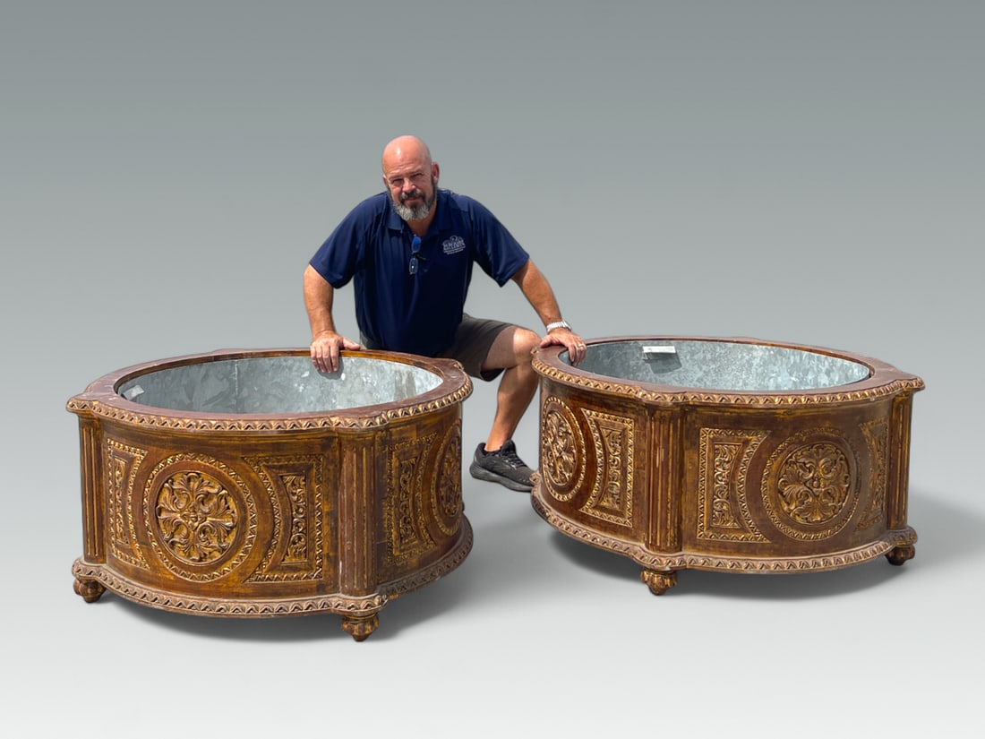 PAIR OF PALATIAL CARVED PLANTERS: PAIR OF PALATIAL CARVED PLANTERS: Pair of Carved & Gilt Palatial Planters, having an overall Foliate motif with floral medallions and Fluted Columns. Raised on ribbed feet. Both have Galvanized sheet 