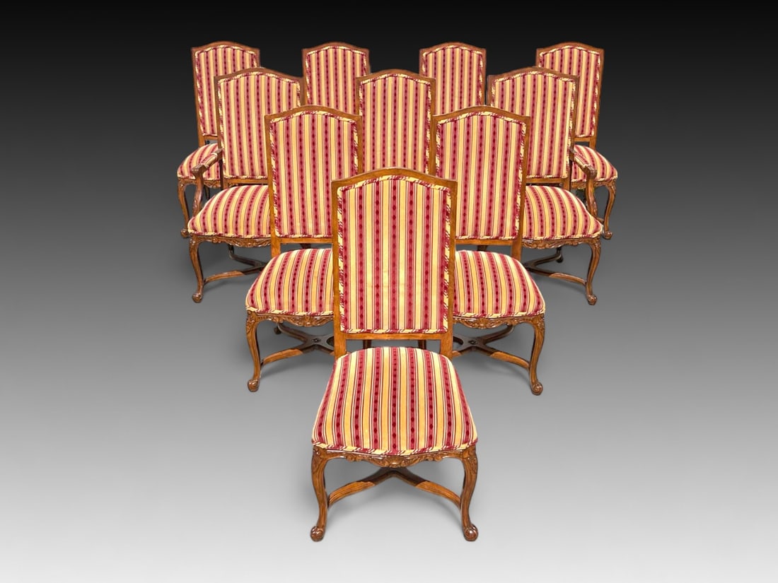 10 CARVED MAHOGANY DINING CHAIRS: 10 CARVED MAHOGANY DINING CHAIRS: Set of ten lovely mahogany chairs upholstered with tasteful red and yellow striped fabric. Each chair measures 43.5" (h) x 21" (w) x 21" (d).