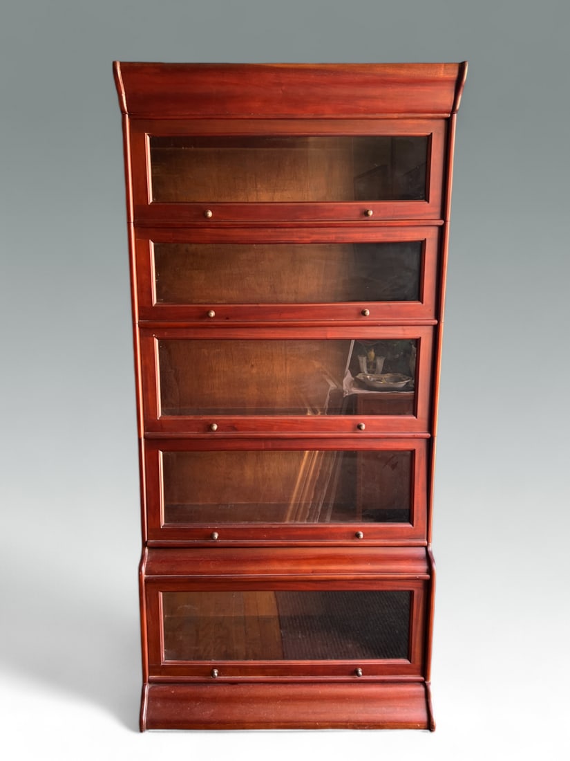 MODERN 5-STACK MAHOGANY LAWYER'S BOOKCASE: MODERN 5-STACK MAHOGANY LAWYER'S BOOKCASE: Sectioned stacking bookcase made of a deep, rich red mahogany. Features knob pulls and Barrister-style hideaway doors on each shelf. Measures 72” (h) x