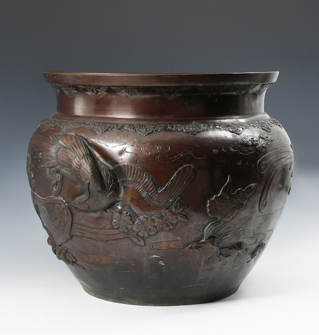 JAPANESE MEIJI PERIOD BRONZE JARDINIERE / PLANTER: JAPANESE MEIJI PERIOD BRONZE JARDINIERE / PLANTER: Bronze Japanese Jardiniere, having a raised bird & floral motif. Approx. 13.5" h x 16.5" Dia.