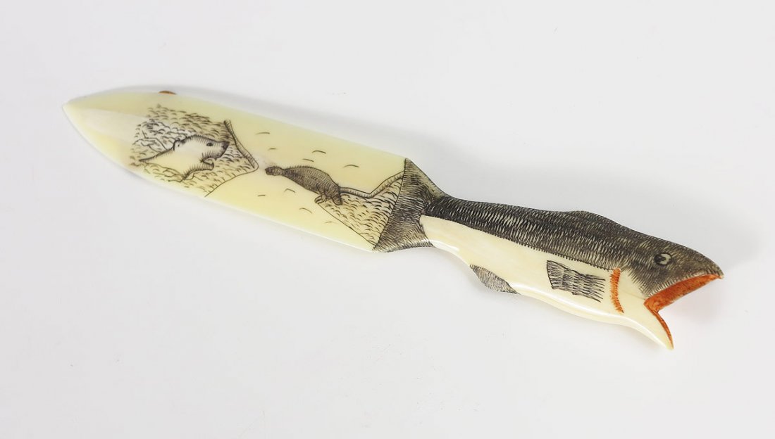 FRANK ELLANNA SCRIMSHAW IVORY LETTER OPENER: FRANK ELLANNA SCRIMSHAW IVORY LETTER OPENER: From noted Alaskan artist Frank Ellanna, and elder of the Inupiang Eskimo, King island. Fish form handle, blade with scene of polar bear and seal. Signed v