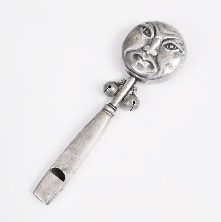 SHIEBLER ART NOUVEAU MAN IN THE MOON BABY RATTLE: SHIEBLER ART NOUVEAU MAN IN THE MOON BABY RATTLE: A rare baby rattle / whistle by Shiebler featuring a man in the moon face on one side and flying bat verso. 4 7/8'' l., approx. 1.1 troy oz.