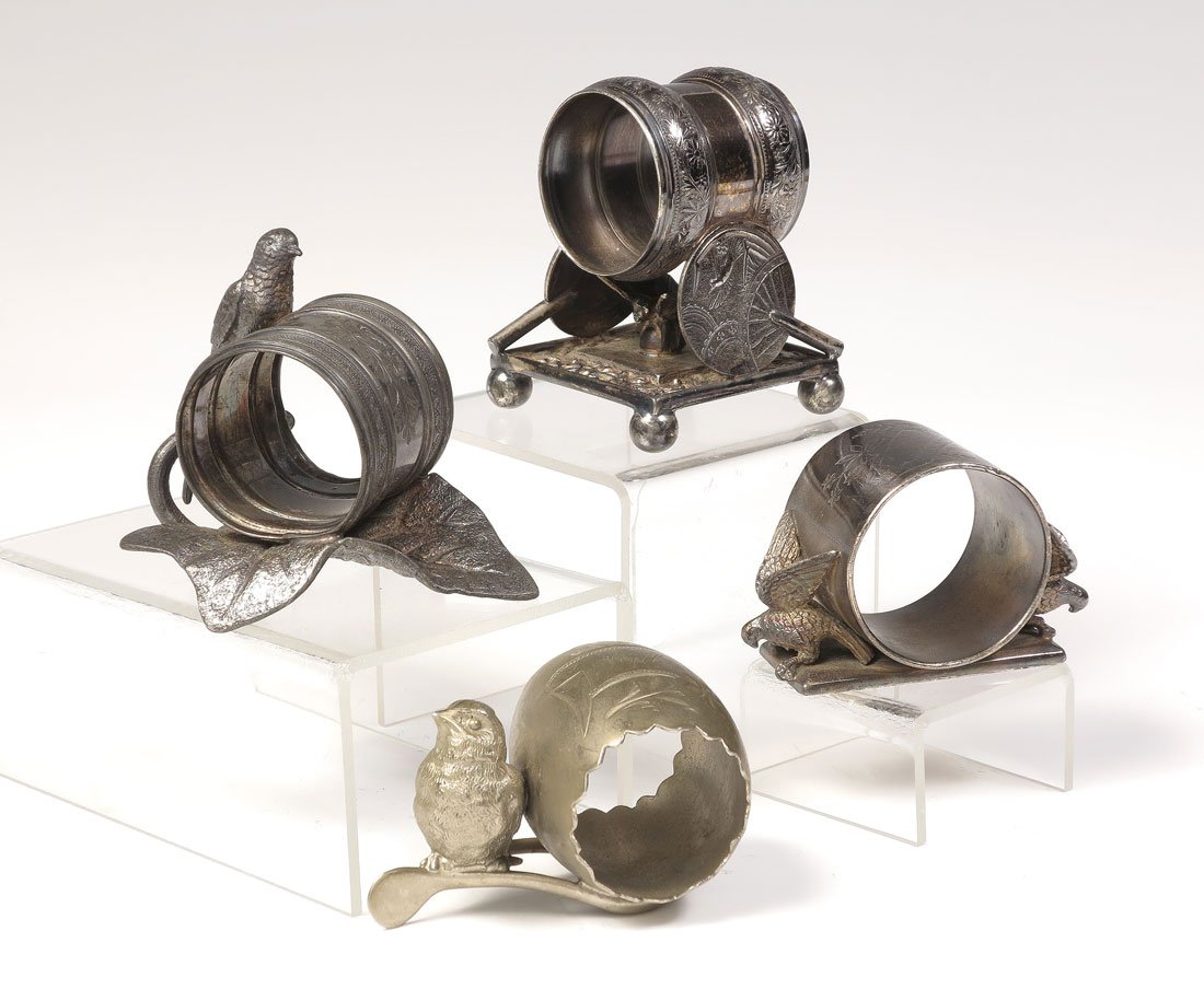 4 FIGURAL BIRDS SILVERPLATE NAPKIN RINGS: 4 FIGURAL BIRDS SILVERPLATE NAPKIN RINGS: 4 total pieces to include 1) Meriden figural birds on either side of ring, #146. 2" h. 2) Meriden bird on branch with leaf base, ring on leaf, #202, engraved 