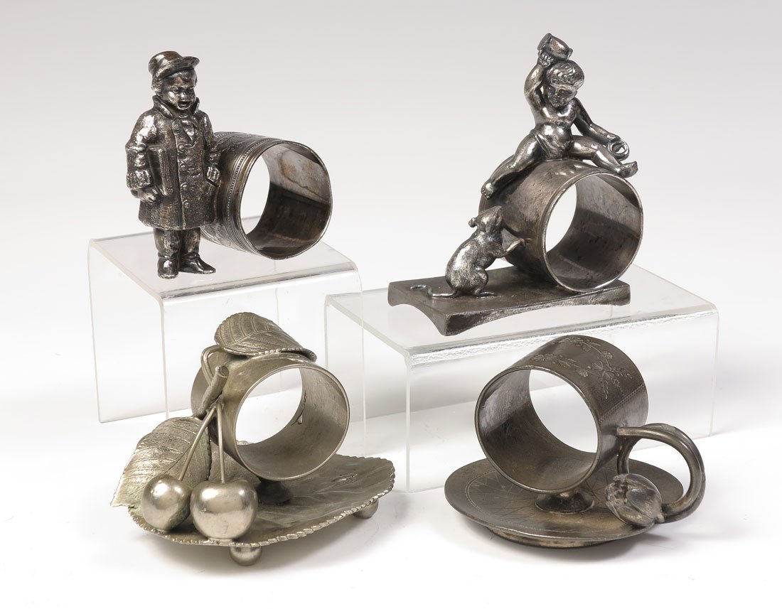 4 FIGURAL SILVERPLATE NAPKIN RINGS: 4 FIGURAL SILVERPLATE NAPKIN RINGS: 4 total pieces to include 1) Middletown child on ring with rat below, #70, 4" h. 2) Unmarked newspaper boy in coat standing next to ring, ring is out of round, #025