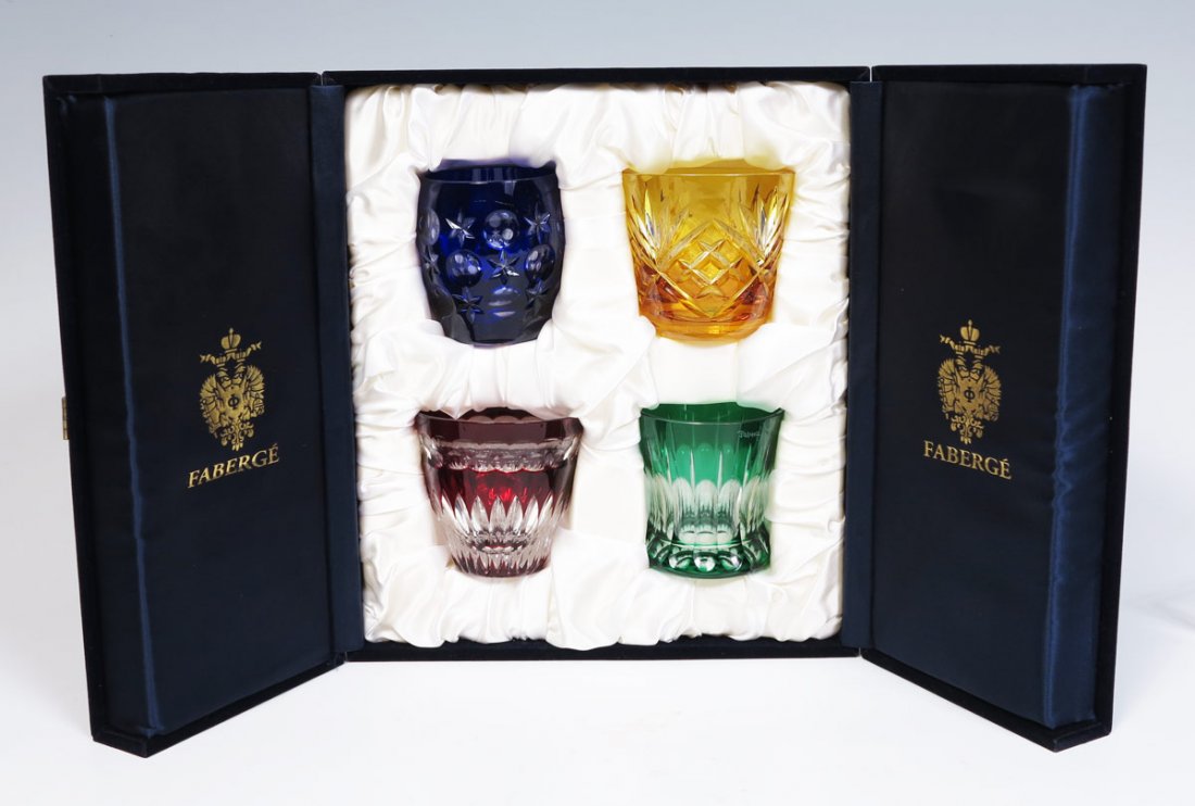 4 CUT TO CLEAR FABERGE TUMBLERS: 4 CUT TO CLEAR FABERGE TUMBLERS: Each of a different color and shape, with original felt exterior presentation box. Box measures 12" x 6" x 10 3/4".
