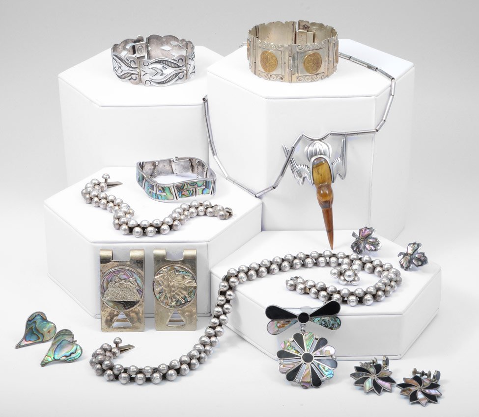 ESTATE MEXICAN 925 JEWELRY LOS CASTILLO SAUL ETC: ESTATE TRAY LOT OF MEXICAN STERLING JEWELRY: To include, Los Castillo Mosaico Azteca bracelet, links inlaid with abalone, approx. 7"l., 1.2 troy oz; Saul sterling and carved tiger eye bird necklace, 1