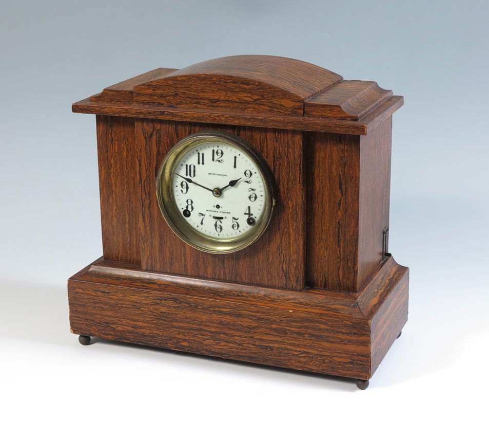 SETH THOMAS SONORA CHIMES MANTLE CLOCK: SETH THOMAS SONORA CHIMES MANTLE CLOCK: Adamantine finish case, porcelain face with Arabic numerals signed Seth Thomas, Sonora Chimes. Key and pendulum in office. 13 3/4'' h. x 15'' x 7''.
