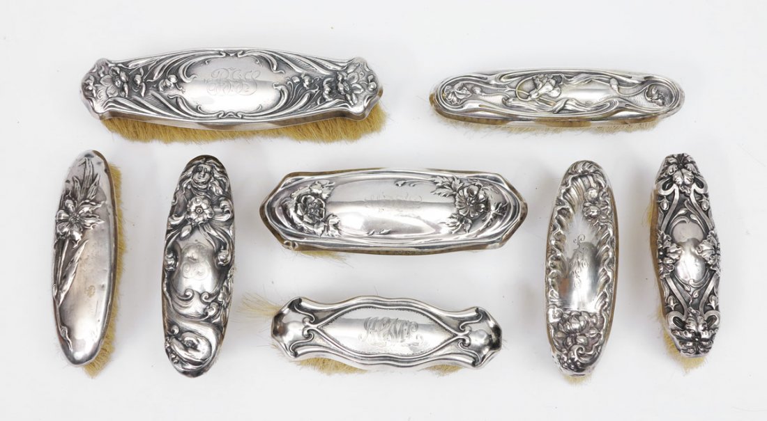 8 ART NOUVEAU STERLING HANDLED CLOTHES BRUSHES: 8 ART NOUVEAU STERLING HANDLED CLOTHES BRUSHES: 8 pieces total to include 1) 2 Mauser one with floral motif, the other with art nouveau lines. 2) Shiebler floral motif, 6 7/8'' x 1 7/8''. 3) Unger Bro