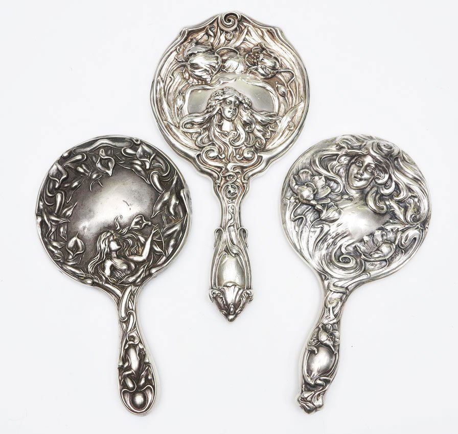 3 ART NOUVEAU STERLING HAND MIRRORS: 3 ART NOUVEAU STERLING HAND MIRRORS: 3 pieces total to include 1) Marshall Field woman holding lily and floral motif, 8 3/4''. 2) Sterling woman below flowers, monogrammed, 9 3/4''. 3) Sterling woman