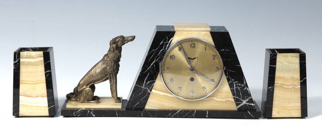 UCRA MARBLE ART DECO CLOCK GARNITURE SET: UCRA MARBLE ART DECO CLOCK GARNITURE SET: Figural cast metal borzoi dog on two toned marble case. Ucra time only movement. 8 1/2" h. x 18 3/4" x 4 1/4". Sold with 2 matching garniture, 6 1/4" h. x 4"