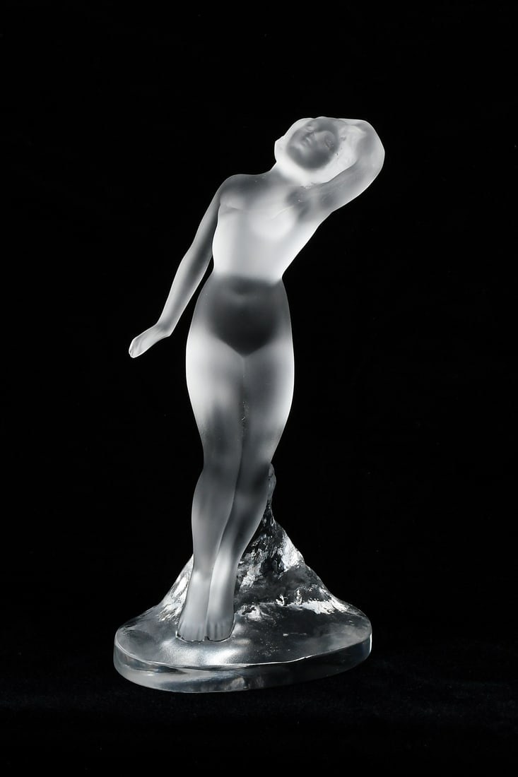 LALIQUE FROSTED CRYSTAL FAINTING NUDE FEMALE: LALIQUE FROSTED CRYSTAL FAINTING NUDE FEMALE: Female fainting on a tree form base, signed under base. Approx. 9.25" h x 4.5" w x 3.125" d.