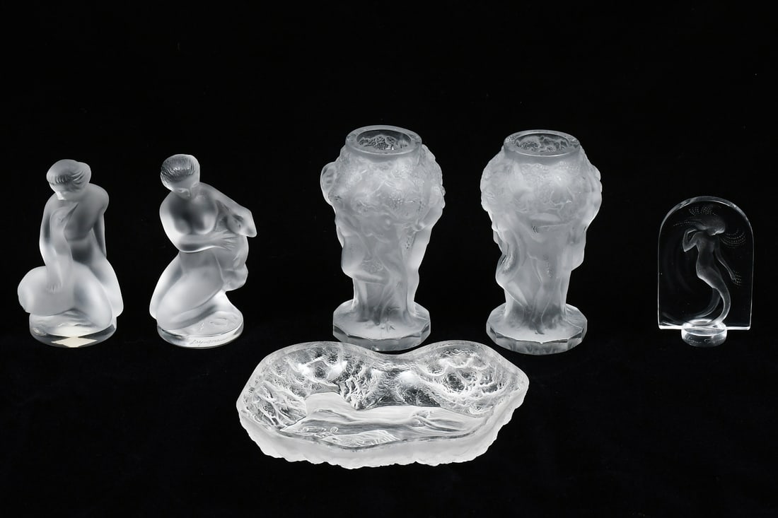 6PC. LALIQUE NUDE FEMALE PIECES: 6PC. LALIQUE NUDE FEMALE PIECES: Six pieces of Lalique crystal. 1) Paired set of nude maidens, one with goat and one with swan, each 4.625” in height; 2) Pair of small vases with maidens in a ga