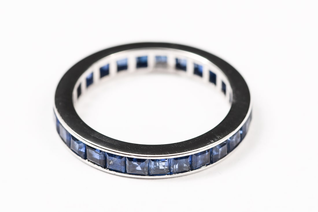 14K STYLISH SAPPHIRE ETERNITY BAND: 14K STYLISH SAPPHIRE ETERNITY BAND: 14K white gold sapphire band containing the following: 24 square calibre cut sapphires measure approx: 2.50 x 2.50 mm TOTAL SAPPHIRE WEIGHT: 2.50 Ct. Approx. Rated 