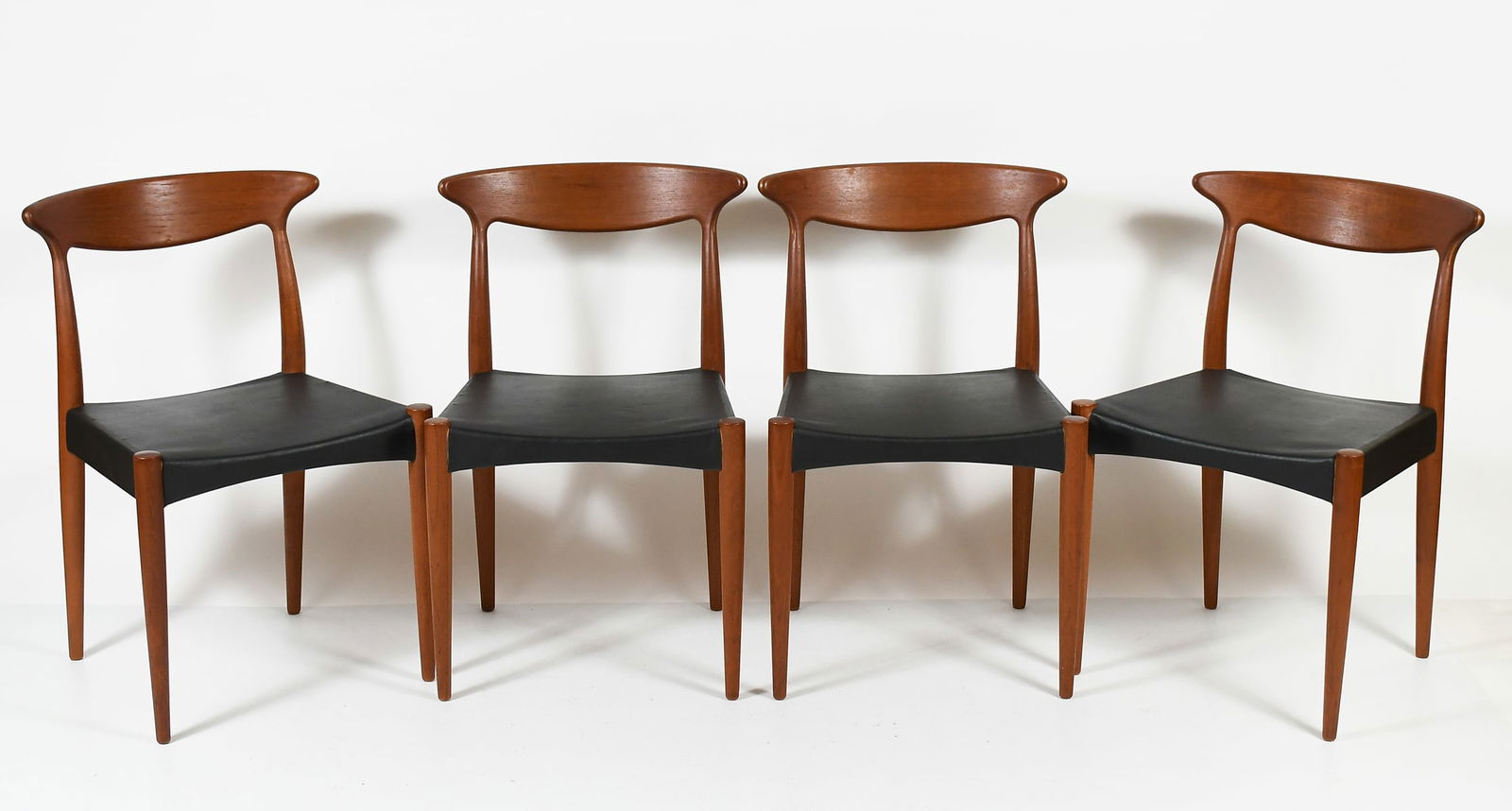 4 MCM ARNE HOVMAND-OLSEN TEAK DINING CHAIRS: 4 MCM ARNE HOVMAND-OLSEN TEAK DINING CHAIRS: Mid-Century Modern Teakwood Side Chair, the seat with original black leatherette. "Danish Control Furniture Makers, Craftsmanship Made in Denmark" label at