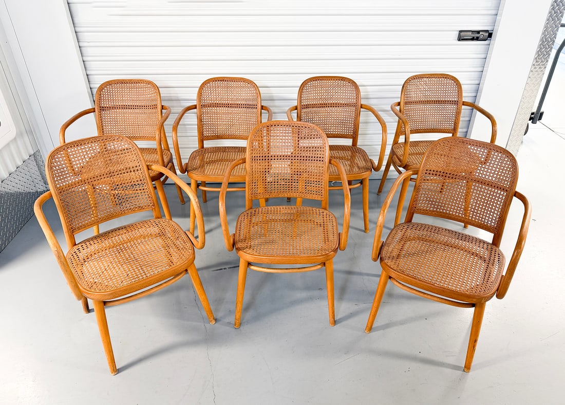 7 JOSEPH HOFFMAN STYLE BENTWOOD & CANE ARMCHAIRS: 7 JOSEPH HOFFMAN STYLE BENTWOOD & CANE ARMCHAIRS: Marked Ligna, Czechoslovakia. Each measures 32” (h) x 17.5” (w) x 15.5” (d).