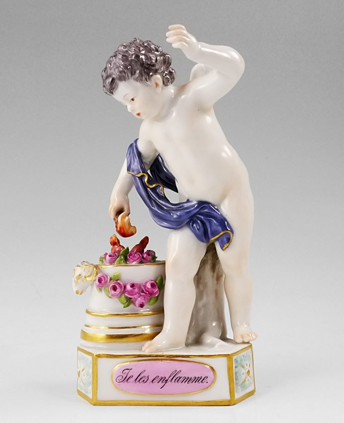 MEISSEN PORCELAIN FIGURAL CHERUB: MEISSEN PORCELAIN FIGURAL CHERUB: Figure of a cherub holding torch over pedestal of flowers. Lower plaque reads ''Te les enflamme''. Blue crossed swords underglaze mark with impressed ''131'' and inci