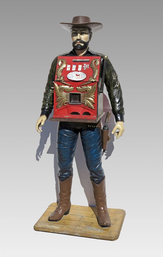LIFE SIZE WESTERN MAN FIGURE W/ FAUX SLOT MACHINE: LIFE SIZE WESTERN MAN FIGURE WITH FAUX SLOT MACHINE: Composite figure of a man dressed in western garb with a faux slot machine in chest. Doors of slot machine open to reveal 2 storage spaces. Overall