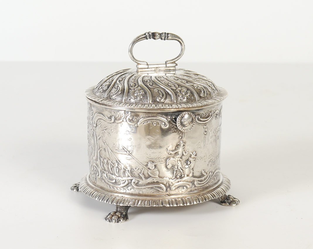 DUTCH SILVER REPOUSSE COVERED BOX: DUTCH SILVER REPOUSSE COVERED BOX: Hinged lid with handle and push button closure, body with repousse scenes of boats, castle, horse and wagon, all with figures. On 4 paw feet. Hallmarked with Dutch e
