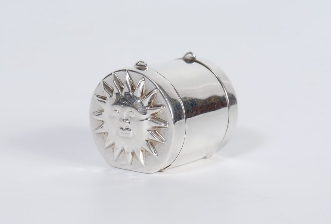 TIFFANY STERLING MOON AND SUN PILL BOX: TIFFANY & CO. STERLING PILL BOX: Hinged lids on either side, one side with applied sun decoration, moon and star other side. Marked Tiffany & Co. 925 Philippines. 1 5/8'' long. Approx. 1.7 troy oz.