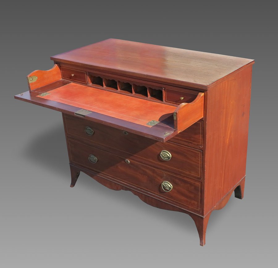 PERIOD BUTLER'S CHEST: PERIOD BUTLER'S CHEST: Mahogany with string inlay, top drawer opens to leather writing surface, 2 drawers and pigeon holes. 3 graduated lower drawers. Brass hardware. Shaped skirt and feet. 38 3/4" h.