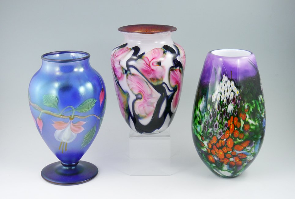 3 PIECE ART GLASS COLLECTION: 3 PIECE ART GLASS COLLECTION: 3 pieces total to include 1) Orient & Flume floral motif footed vase. Signed on base 9 1/4" h. x 5 1/2". 2) Shawn Messenger "Landscape" art glass vase, signed and dated 1