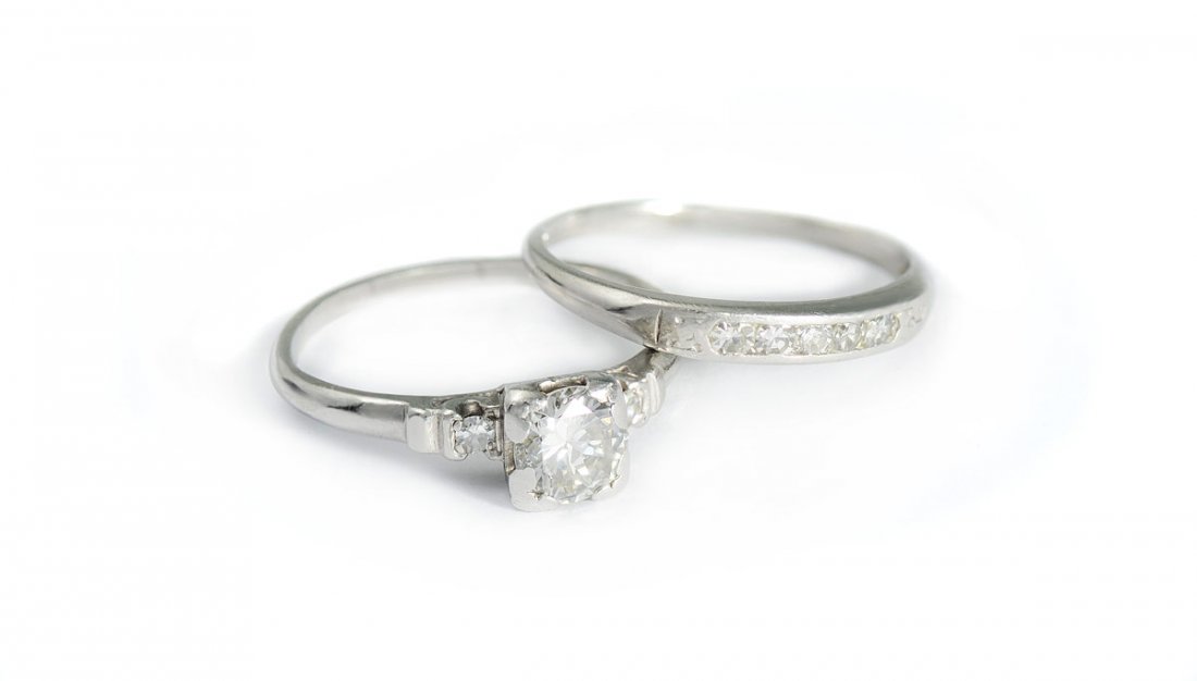 PLATINUM DIAMOND BRIDAL SET SZ 7: PLATINUM .88 CTW DIAMOND BRIDAL SET: Platinum engagement ring and band centering an approx. .63 Ct round brilliant cut diamond. Rated VS2 in clarity and H in color. 7 round single cut diamonds totalin