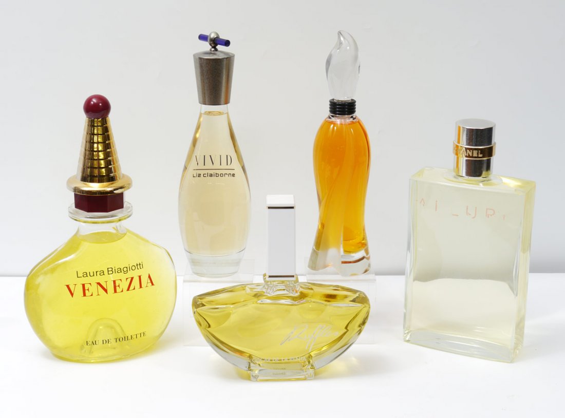 COLLECTION OF 5 FACTICE PERFUME BOTTLES: COLLECTION OF 5 FACTICE PERFUME BOTTLES: 5 pieces to include 1) "Ruffles", Oscar De La Renta, 10" h. x 9 1/2". 2) "Vivid", Liz Claiborne, note spotting to lid, 14" h. 3) "Allure", Chanel, note wear to