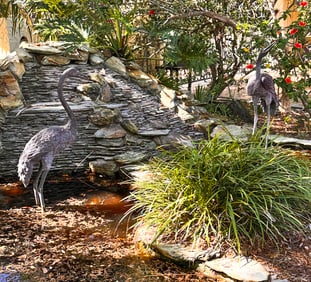 TWO LIFE-SIZED BRONZE CRANE SCULPTURES