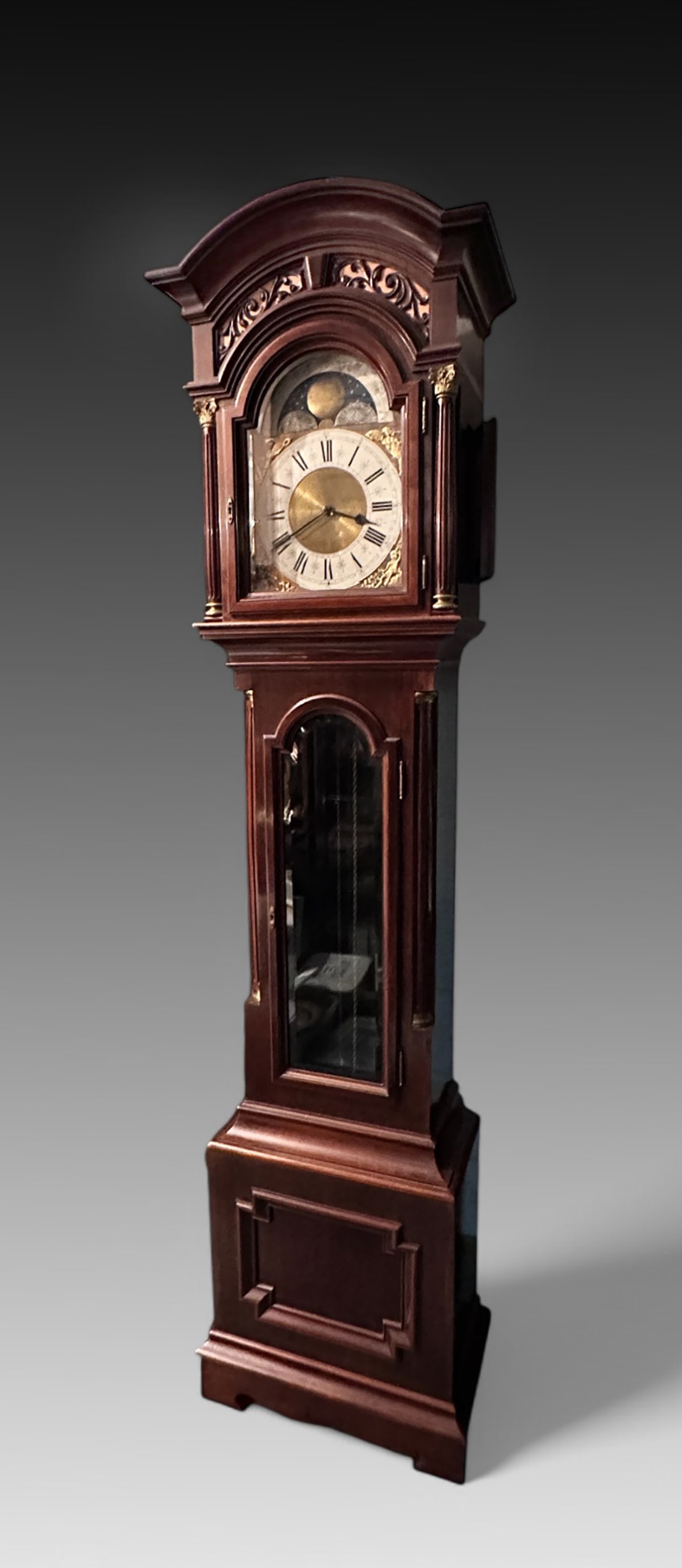 MOON PHASE GRANDFATHER CLOCK: MOON PHASE GRANDFATHER CLOCK: Stately tall grandfather clock with roman numeral and moon phase display. Measures 89" (h) x 22.625" (w) x 12.625" (d). Provenance: Albert and Carmen Bombach Estate, Old 