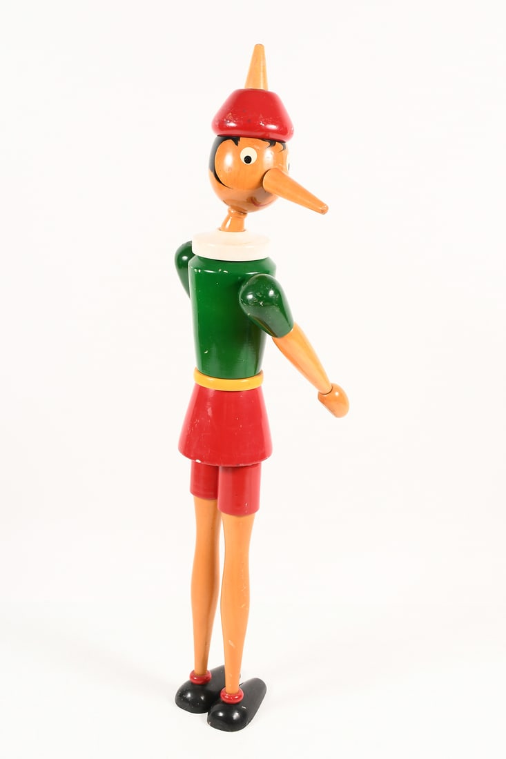 LARGE WOODEN PINOCCHIO BY GIOCATTOLI BREVETTAT: LARGE WOODEN PINOCCHIO BY GIOCATTOLI BREVETTATI: 50" tall handcrafted Italian wooden Pinocchio figure with articulated neck, arms, and legs. Stands upright, with vibrant red & green painted clothing. 