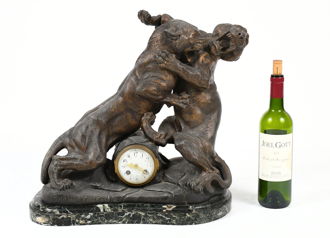 THOMAS CARTIER SPELTER TIGER MANTEL CLOCK: THOMAS CARTIER SPELTER TIGER MANTEL CLOCK: Thomas Francois Cartier, French (1879-1943). Patinated Spelter mantel clock with two fighting Tigers. Mounted on a marble base. Approx. 17.75" h x 18.25" w x