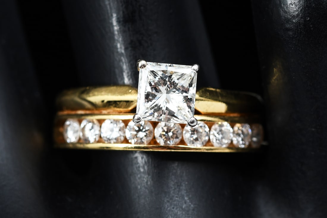 REGAL 18K BRIDAL SET: REGAL 18K BRIDAL SET: This exquisite bridal set is 18 karat yellow gold with one Princess cut diamond weighing approx. 1.04 Ct. Also has 9 round brilliant cut diamonds weighing approx. .90 Ct. Overall