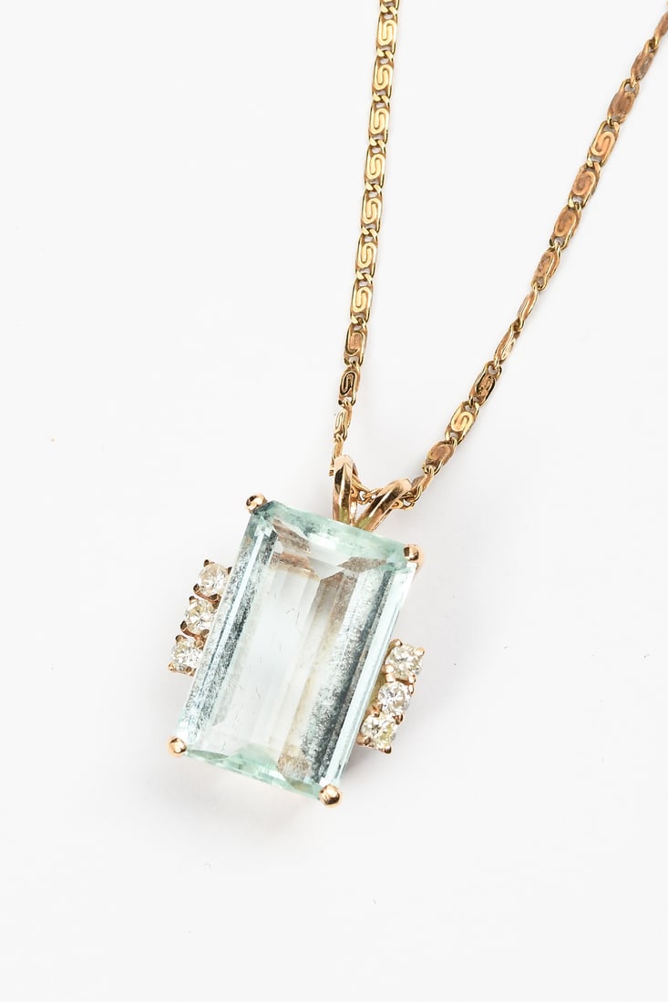 IMPRESSIVE AQUAMARINE & DIAMOND PENDANT: IMPRESSIVE AQUAMARINE & DIAMOND PENDANT: This sizable 14K pendant contains 1 emerald cut aquamarine Weight approx. 10.70 Ct. Rated VVS in clarity (Type I), gB in Hue, 2 in Tone, and 2 in Saturation. 6