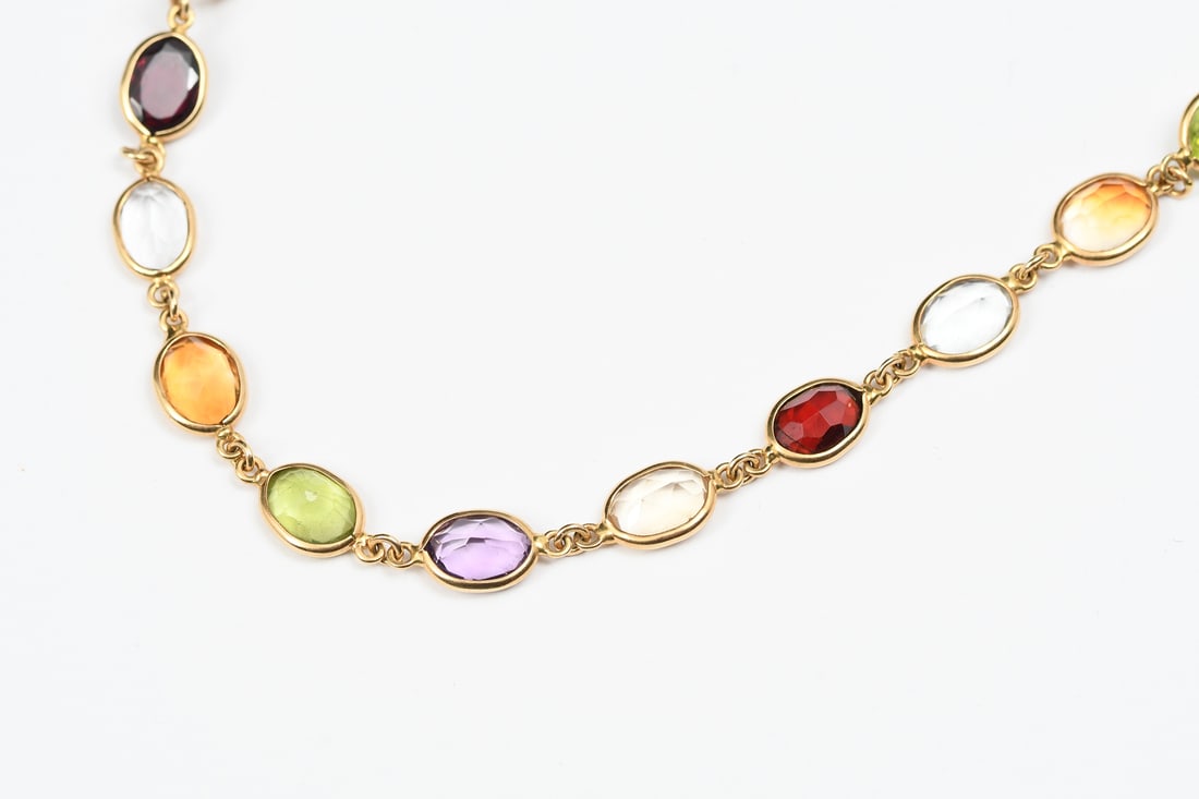 18K 30.00 CTW GEMSTONE NECKLACE: 18K 30.00 CTW GEMSTONE NECKLACE: 18K yellow gold necklace contains 29 oval mixed cut gemstones includes citrine, amethyst, garnet, Peridot and topaz. WEIGHT: 30.00 Ct. Approx. The gemstones are bezel