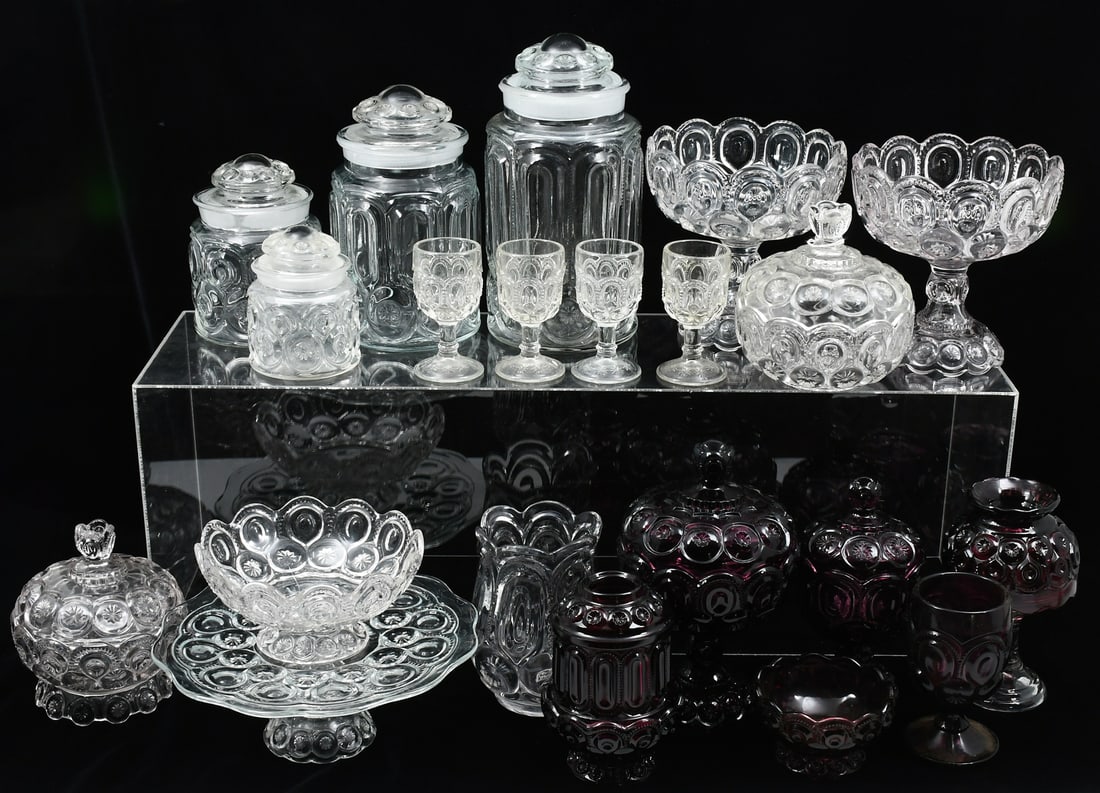 21 PC. L.E. SMITH AMYTHEST & CLEAR MOON & STAR: 21 PC. L.E. SMITH AMYTHEST & CLEAR MOON & STAR: Footed bowls, canisters, and goblets in both pale white and deep purple. Largest piece is a white canister measuring 11.5” in height.