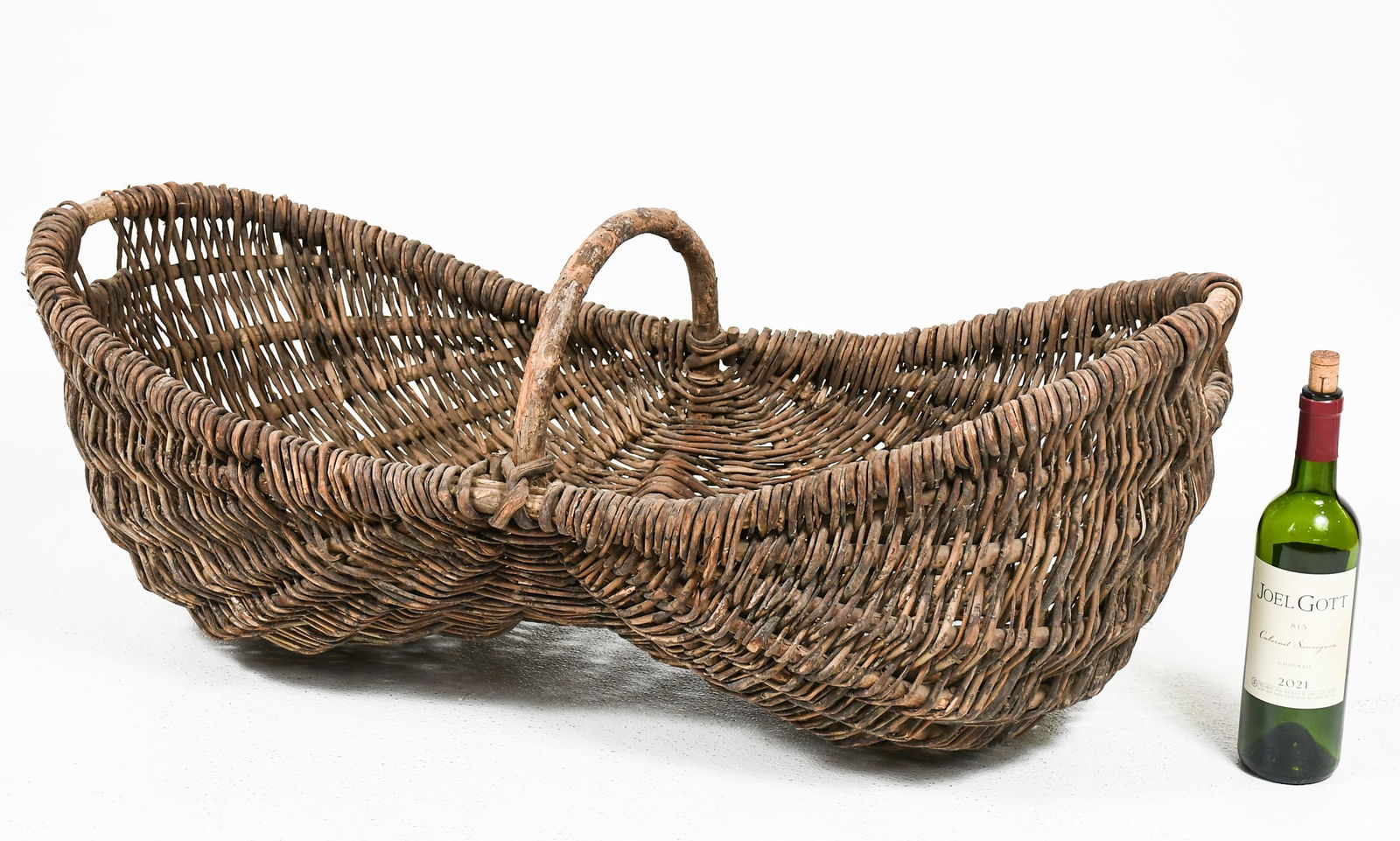 FRENCH WICKER BUTTOCKS GRAPE WINE HARVEST BASKET: FRENCH WICKER BUTTOCKS GRAPE WINE HARVEST BASKET: French Champagne Grape Gathering Basket. Approx. 15.5" h x 38.25" w x 17.75" d.
