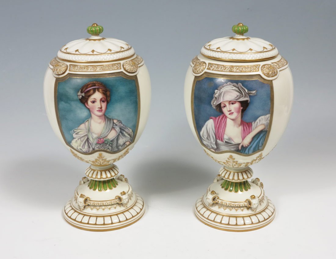 ROYAL WORCESTER PORTRAIT URNS CA. 1890 ARTIST SIGN: PAIR ROYAL WORCESTER PORCELAIN PORTRAIT URNS: Artist signed RID, each with the image of a beautiful woman. Embossed and gilt body with a series of masks along the base. Urn with black hair bears the W