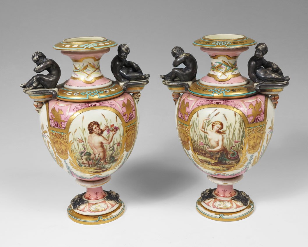 PAIR ROYAL WORCESTER VASES MYTHOLOGICAL IMAGES: PAIR ROYAL WORCESTER PORCELAIN VASES: Rich with mystical images, bracket handles supporting full figure putti. Approx. 11'' tall. Blurred mark.