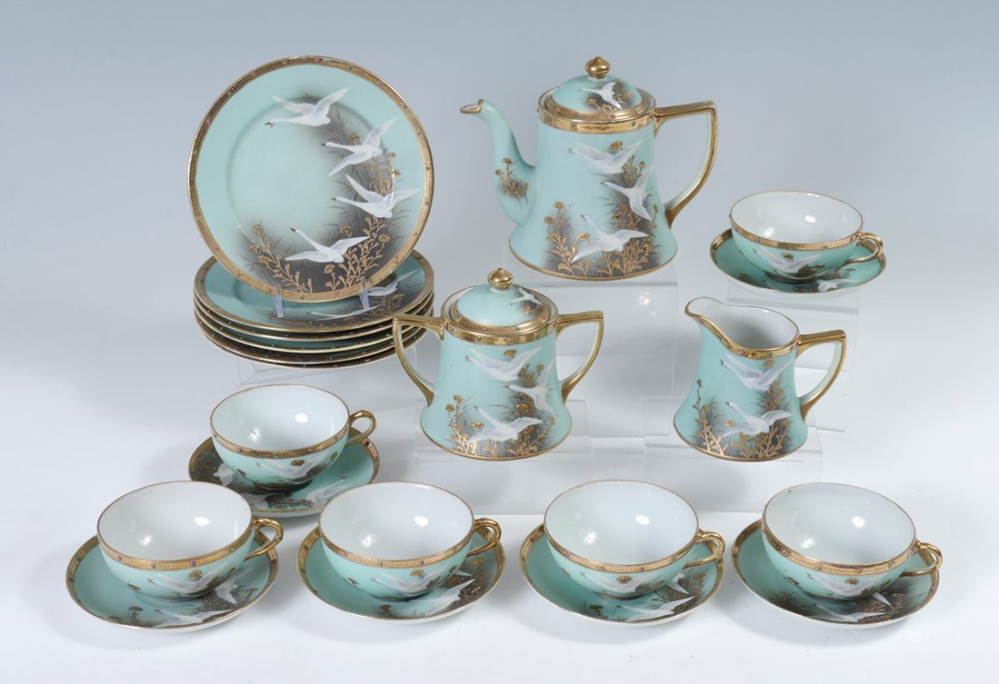 SNOW GEESE HAND PAINTED NIPPON TEA SET: SNOW GEESE HAND PAINTED NIPPON TEA SET: 21 pieces hand painted with snow geese in flight motif to include teapot 6 1/8" h. x 7 1/2"), covered sugar (5" x 6"), open creamer (4" h.), 6 luncheon plates (