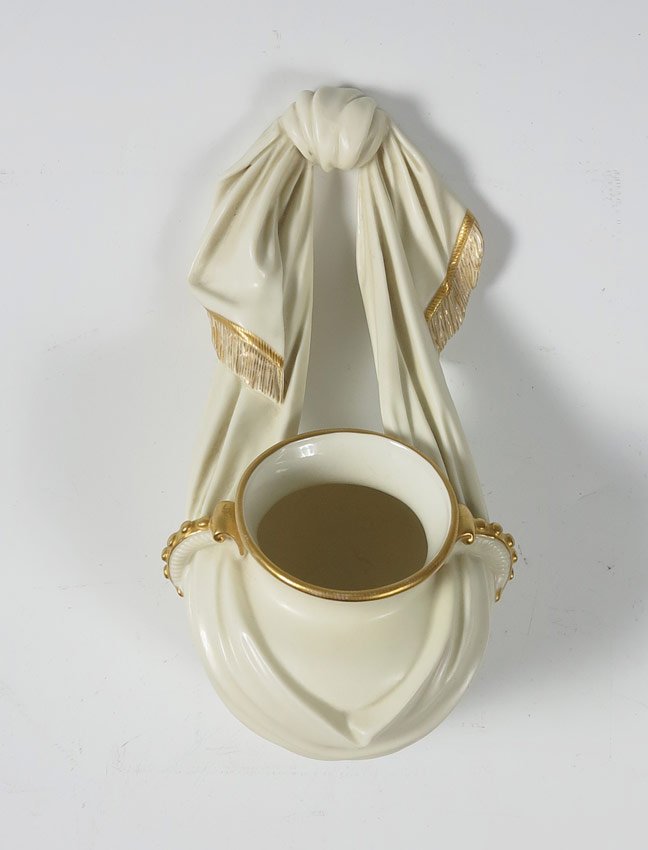 ROYAL WORCESTER WALL POCKET: ROYAL WORCESTER WALL POCKET: Draped fabric effect, parcel gilt, 9 1/2"L. x 4" wide. English registry mark for 1906.