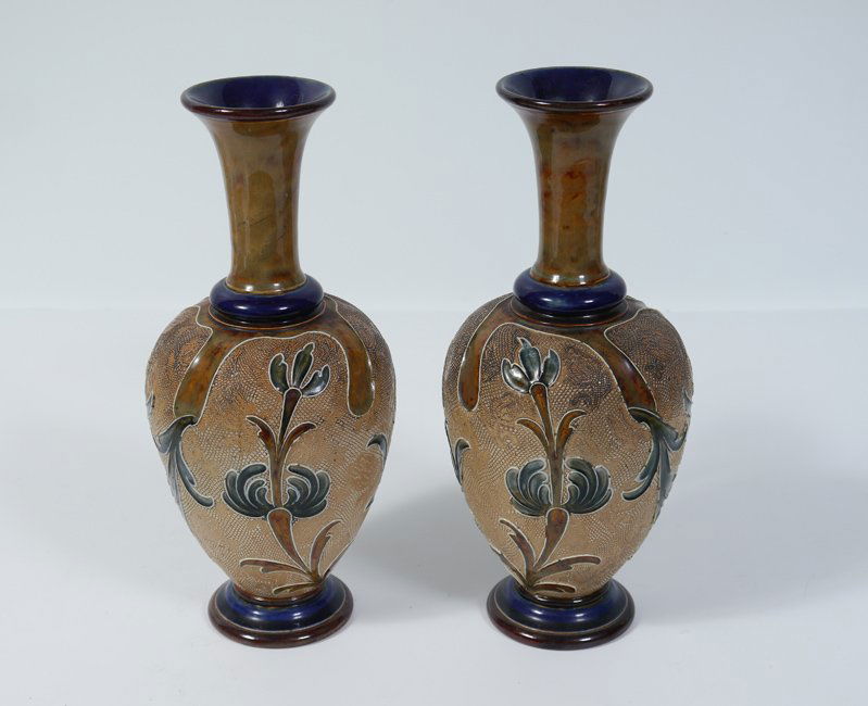 PAIR DOULTON LAMBETH EARTHENWARE VASES: PAIR DOULTON LAMBETH EARTHENWARE VASES: Incised decoration with foliate motifs. Impressed Doulton Lambeth markings with incised artist signature on base. 11" h. x 4 1/2" dia. Doris Baker-Mansergh Esta
