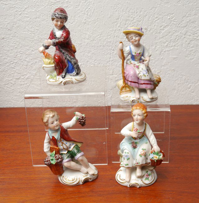4 SITZENDORF PORCELAIN FIGURES: 4 SITZENDORF PORCELAIN FIGURES: 4 pieces total to include 1) Boy in robe sitting by a fire, 4" h. 2) Seated boy with grapes, 3 3/4" h. 3) Girl seated with flowers, 4". 4) Seated girl with rake, 3 3/4"