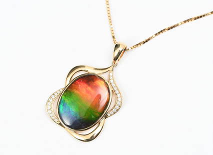 VIBRANTLY HUED AMMOLITE & DIAMOND 14K/18K PENDANT: VIBRANTLY HUED AMMOLITE & DIAMOND 14K/18K PENDANT: This striking 14K pendant contains 1 oval vividly hued Ammolite, 20 x 14.7 mm, 24 round full cut diamonds at 0.15 carat total weight, G-H in color,