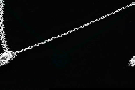 PLATINUM EYECATCHING DIAMOND SLIDE NECKLACE: PLATINUM EYECATCHING DIAMOND SLIDE NECKLACE: This eye-catching platinum diamond necklace contains a bezel mounted slide with 1 round brilliant cut diamond. WEIGHT: approximately .90 Ct. Rated SI1 in