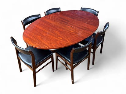 DANISH DINING TABLE W/ 2 LEAVES & 6 DINING CHAIRS: DANISH DINING TABLE W/ 2 LEAVES & 6 DINING CHAIRS: Oval Rosewood Dining Table with two Leaves. Also included are Six Danish Oak Dining Chairs with Black faux leather upholstery, possibly Eric Buch.