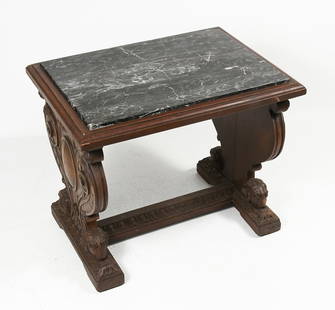 LATE VICTORIAN HEAVILY CARVED MARBLE TOP TABLE: LATE VICTORIAN HEAVILY CARVED MARBLE TOP TABLE: Walnut Marble top side table with carved Cabochon and scrolling sides. Ram's heads at feet with foliate carved stretcher. Approx. 22.5" h x 27" w x 20"