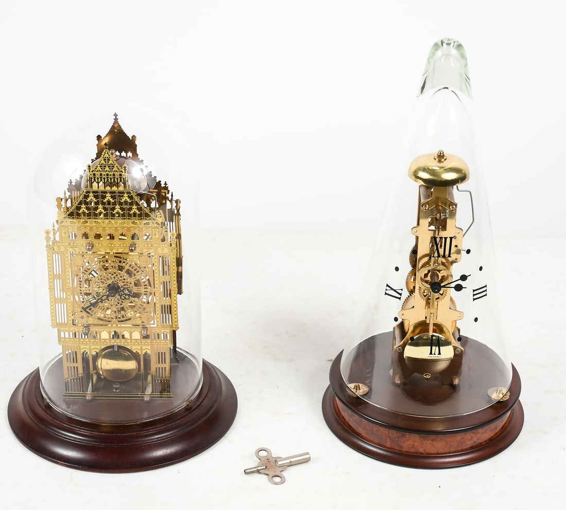 2 SKELETON CLOCKS UNDER GLASS: 2 SKELETON CLOCKS UNDER GLASS: Both by Franz Hermle. 1) Big Ben, measures 11.5” in height overall with glass dome; 2) Skeleton clock under conical glass cover, measures 14” in height overa
