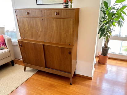 TEAK 2-PART FALLFRONT DESK & CABINET: TEAK 2-PART FALLFRONT DESK & CABINET: Danish Modern 2- Drawer over a drop front Compartmented desk. All resting upon a double sliding door cabinet base. Approx. 47.5" h x 47.5" w x 16" d.
